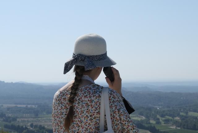 A student looks out over the green landscape of Beaux de Provence, France.