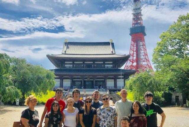 Students standing in front of a palace and Tokyo Tower
