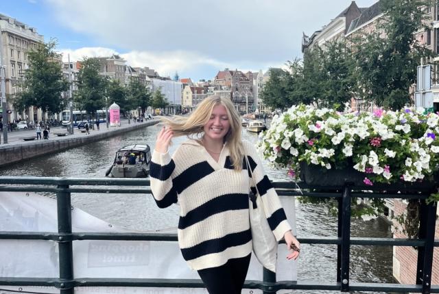 Katie standing on a bridge by the canal in Central Amsterdam