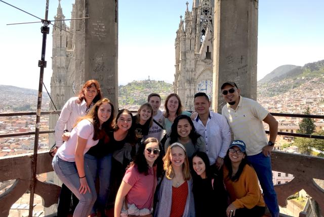 a group of IES Abroad students and staff standing atop Iglesia La Basilica, overlooking Quito city