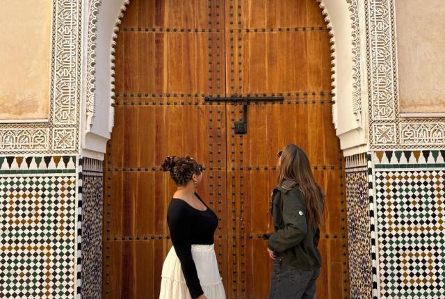 Two Female Students in Rabat's Medina Looking Upwards