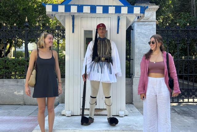 Female students posing with guard in Athens, Greece