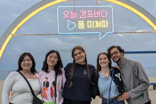 A photo of students smiling on a beach in Seoul