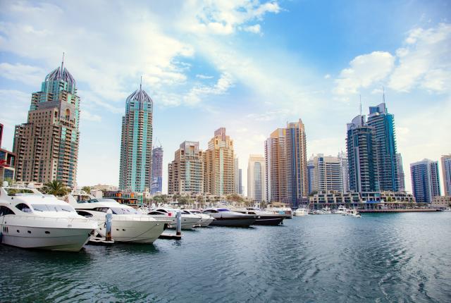 boats in front of dubai skyline