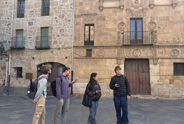 Four students look around on the streets of Salamanca, Spain.
