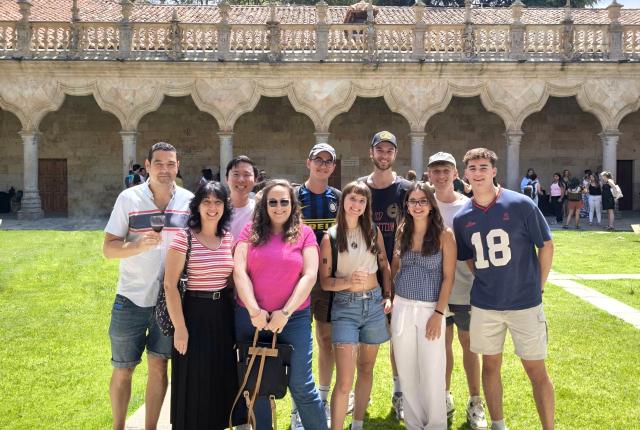 A Group of Students and their teacher in the IES Abroad commons on a sunny day.