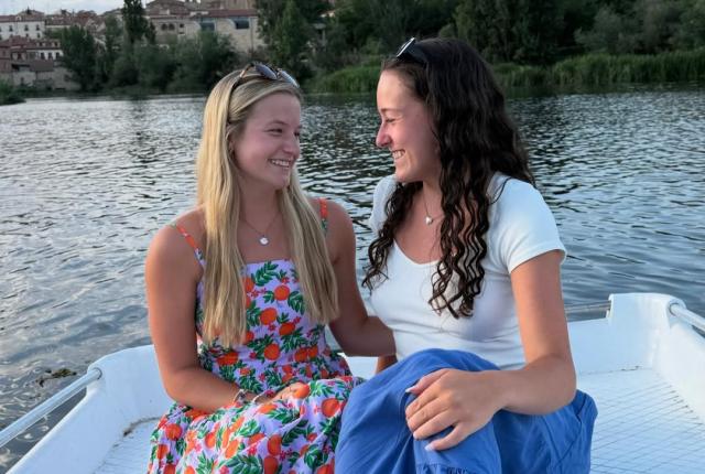 Two female students smile on the rowboats in Salamanca.