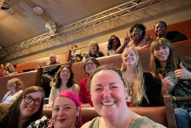 London theatre faculty and students sitting in a theatre. 
