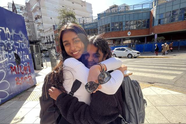 two students hugging and smiling in Buenos Aires
