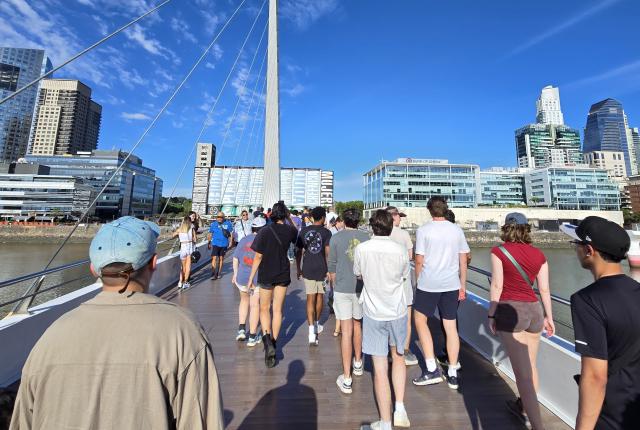 a group of students walking across a bridge in Buenos Aires