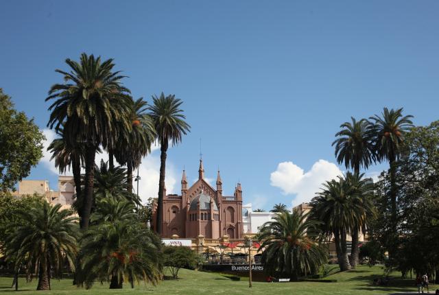 a scenic building in a palm tree-lined Buenos Aires park on a clear day