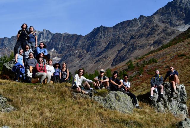 Students hike in the Alps on a sunny day with their classmates on a field trip from Freiburg, Germany.