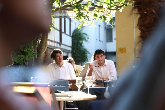 Two students eat in the garden at IES Abroad Freiburg for the student goodbye dinner.