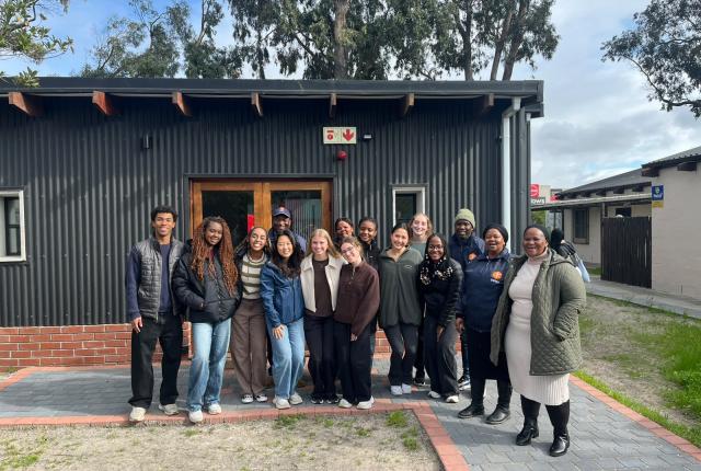 Students studying health in Cape Town stand as a group in front of building