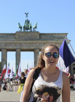 student posing in front of Brandenburg Gate in Berlin