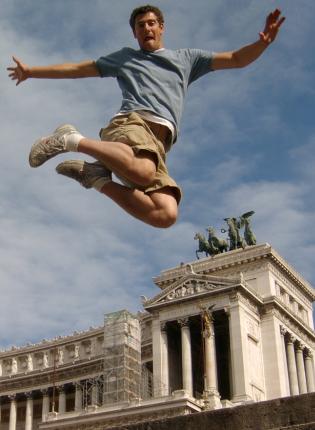 a student jumping for a fun photo at Altar of the Fatherland