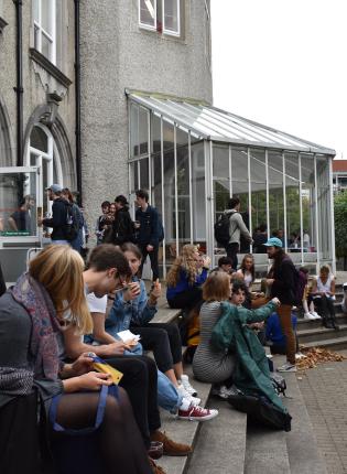 students sitting outside the architecture building at University College Dublin