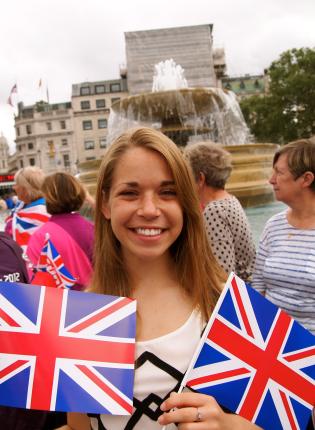 a student posing for a photo with the UK flag