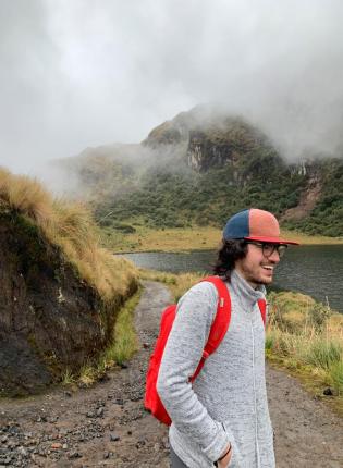 a candid photo of a student smiling in Ecuador's mountains
