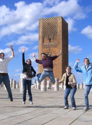 Students jumping outside of Hassan tower in Rabat, Morroco