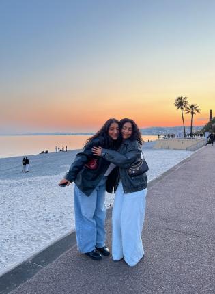 two students hugging on Nice beach at sunset