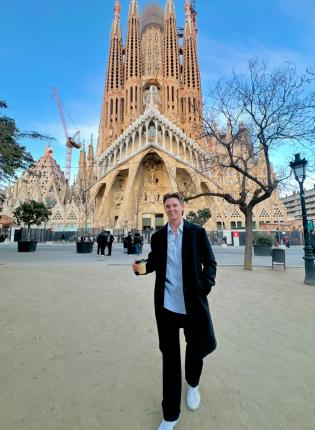 IES Abroad Barcelona intern on his way to work past La Sagrada Familia