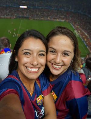 two students pose for a photo at a Barcelona football game.