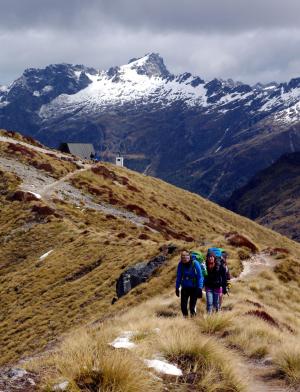 students backpacking among the mountaintops in New Zealand