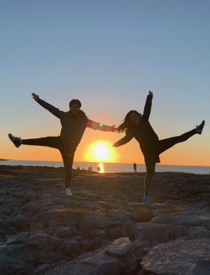 two students pose for a fun photo at sunset in Ireland