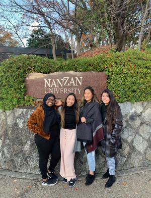students pose for a photo in front of the Nanzan University sign in Nagoya