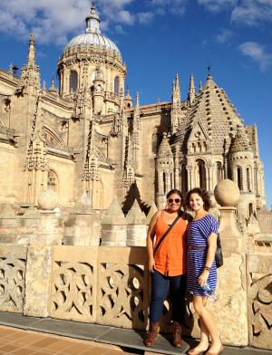 two students pose for a photo in front of the New Cathedral of Salamanca