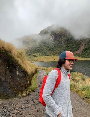 a candid photo of a student smiling in Ecuador's mountains