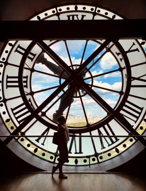 a student's silhouette behind a clock tower at Musee D'orsay