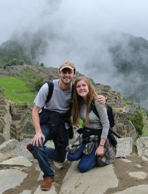 two students pose for the camera in front of machu picchu