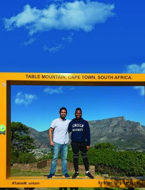 Two Internship students standing in front of Table Mountain in Cape Town