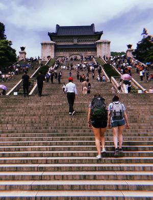 shanghai students walking up the steps toward a mausoleum