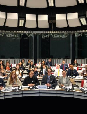 Students sit in three rows and look at the camera as they take part in a Model EU 