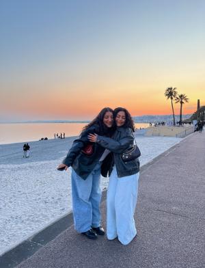 two students hugging on Nice beach at sunset