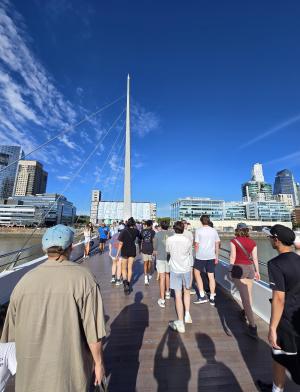 a group of students walking across a bridge in Buenos Aires