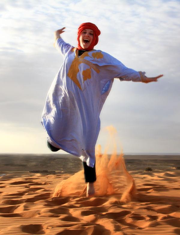 a student jumps for a fun photo in the Saraha Desert in Morocco