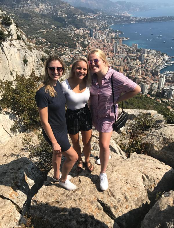 Three students pose in the hills above Monco