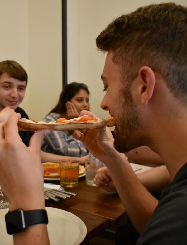 Students eat pizza in Italy