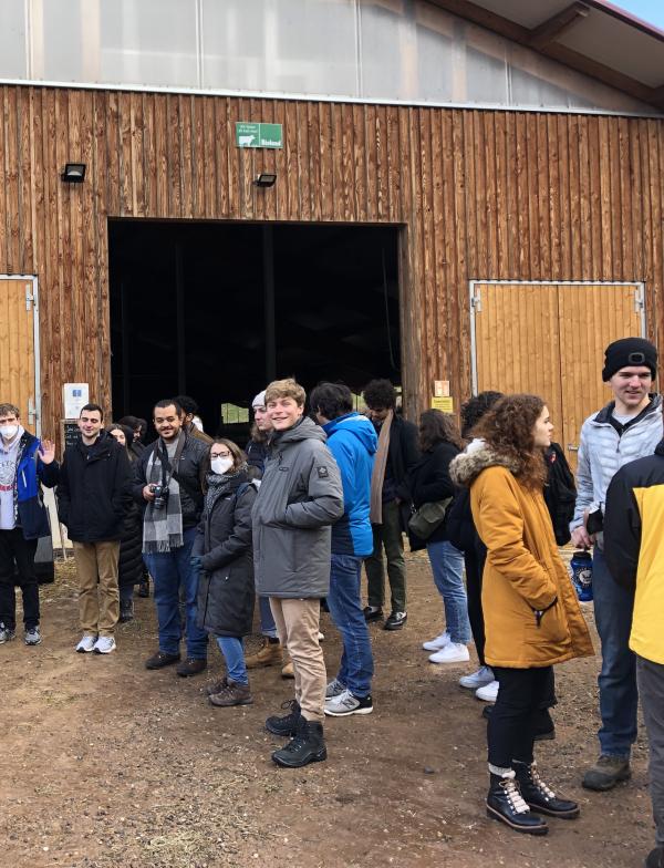 Students standing outside a barn in Freiburg.