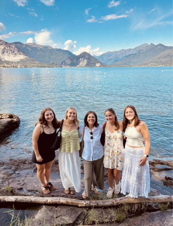 Five individuals standing in front of Lake Maggiore in Stresa, Italy