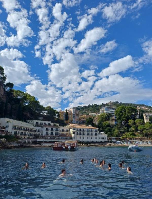 Group of students swimming in the water near Sicily.
