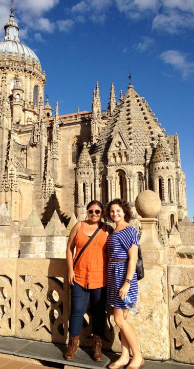 two students pose for a photo in front of the New Cathedral of Salamanca