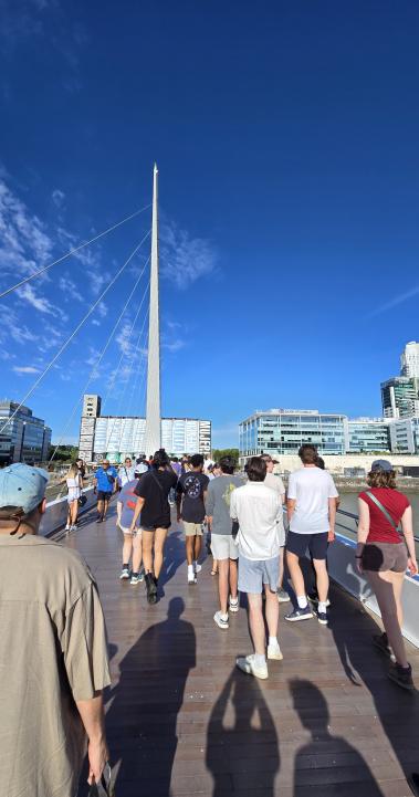 a group of students walking across a bridge in Buenos Aires