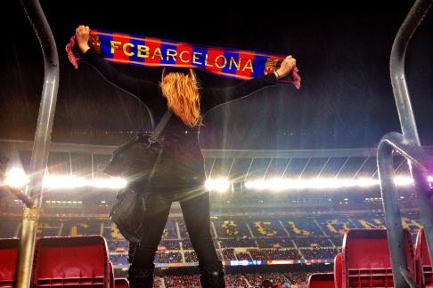 student rooting for the Barcelona football team at a game