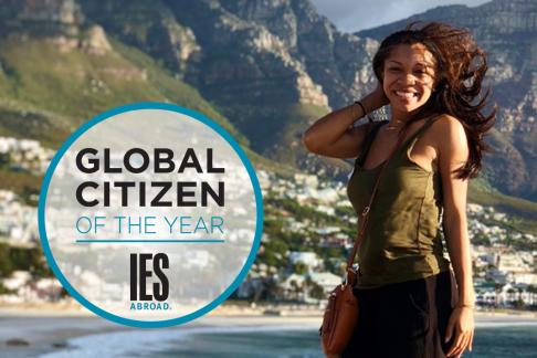 a student standing seaside with her hair blowing in the wind and the Global Citizen of the Year logo beside her