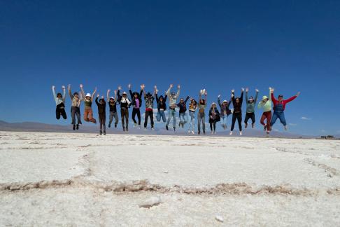 students jumping in a line in Jujuy salt flats
